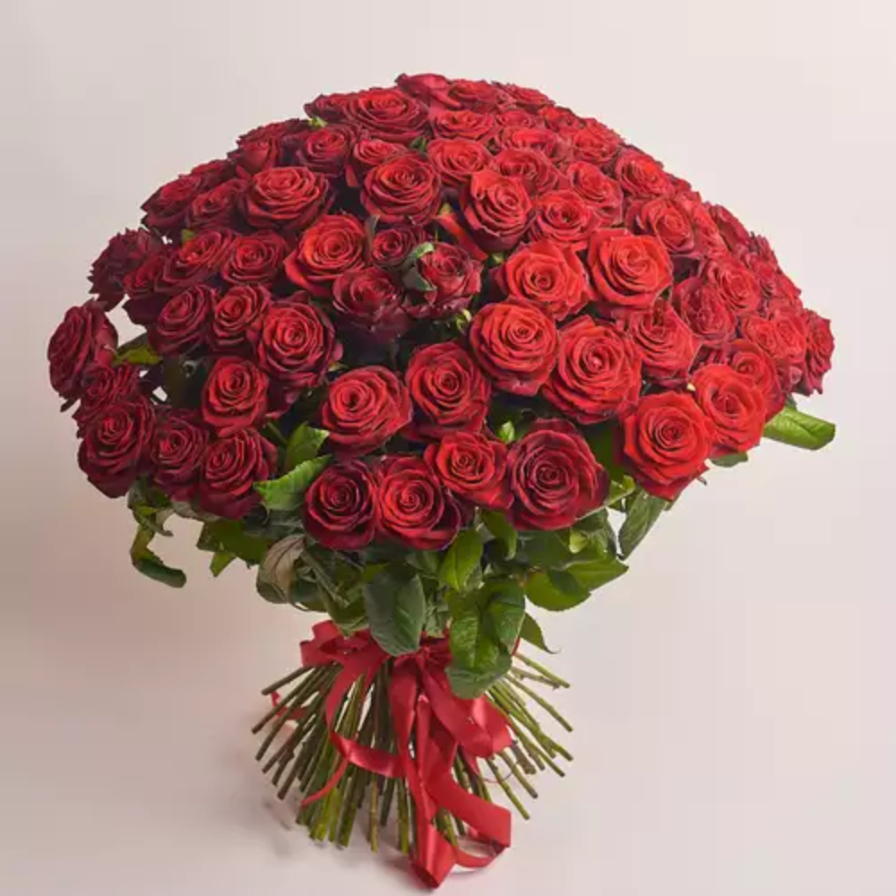 Large luxury bouquet of fresh red roses arranged in a full dome shape with green foliage and red ribbon, premium romantic gift by Favish Blooms Dubai