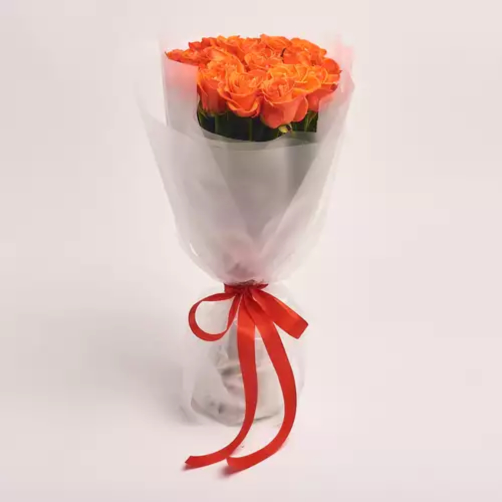 Elegant bouquet of fresh orange roses wrapped in white paper with a red ribbon, premium floral gift by Favish Blooms Dubai