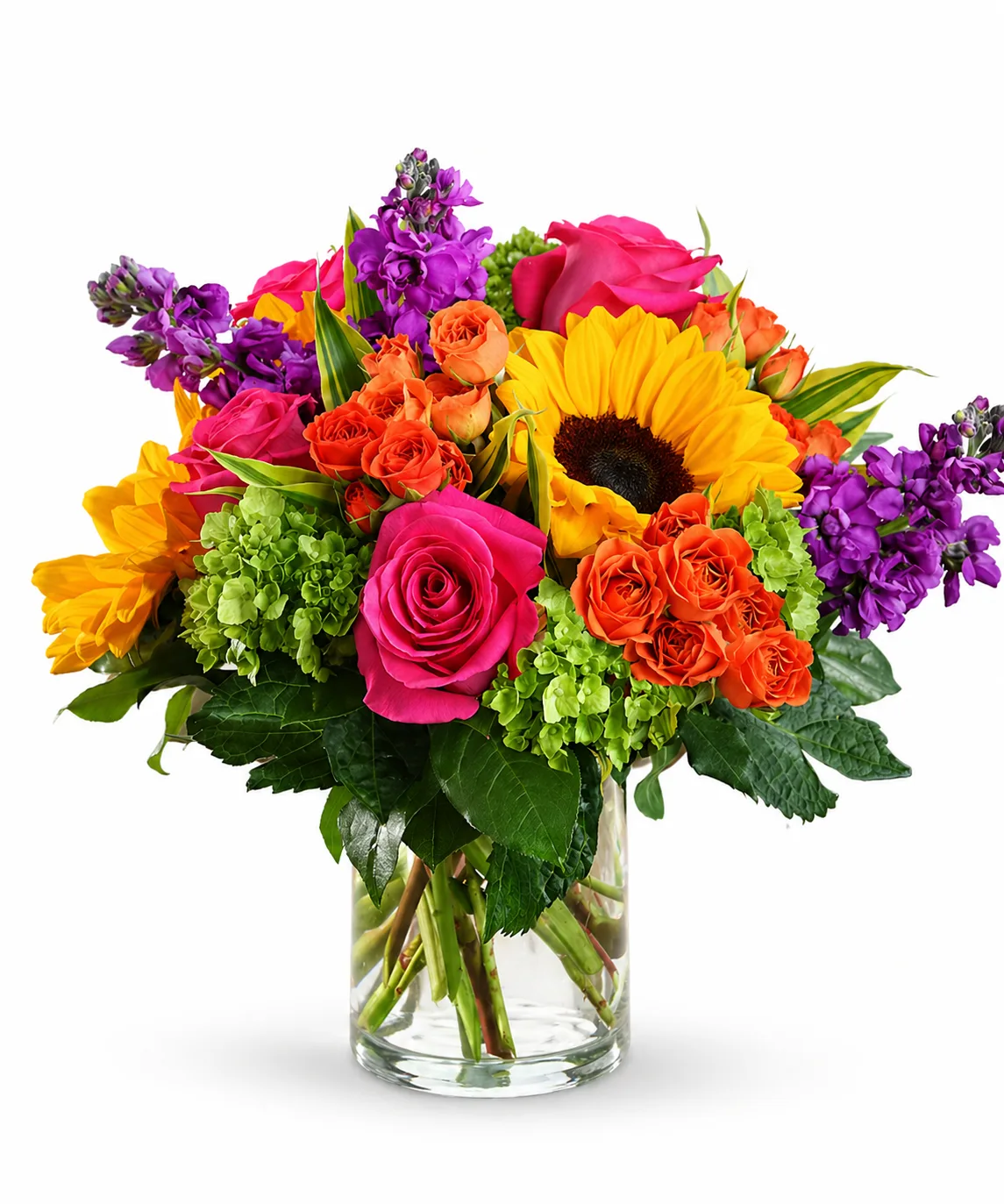 Vibrant mixed flower arrangement with sunflowers, pink roses, orange spray roses, purple blooms, and lush greenery in a glass vase, perfect thank you flowers to show appreciation and gratitude.