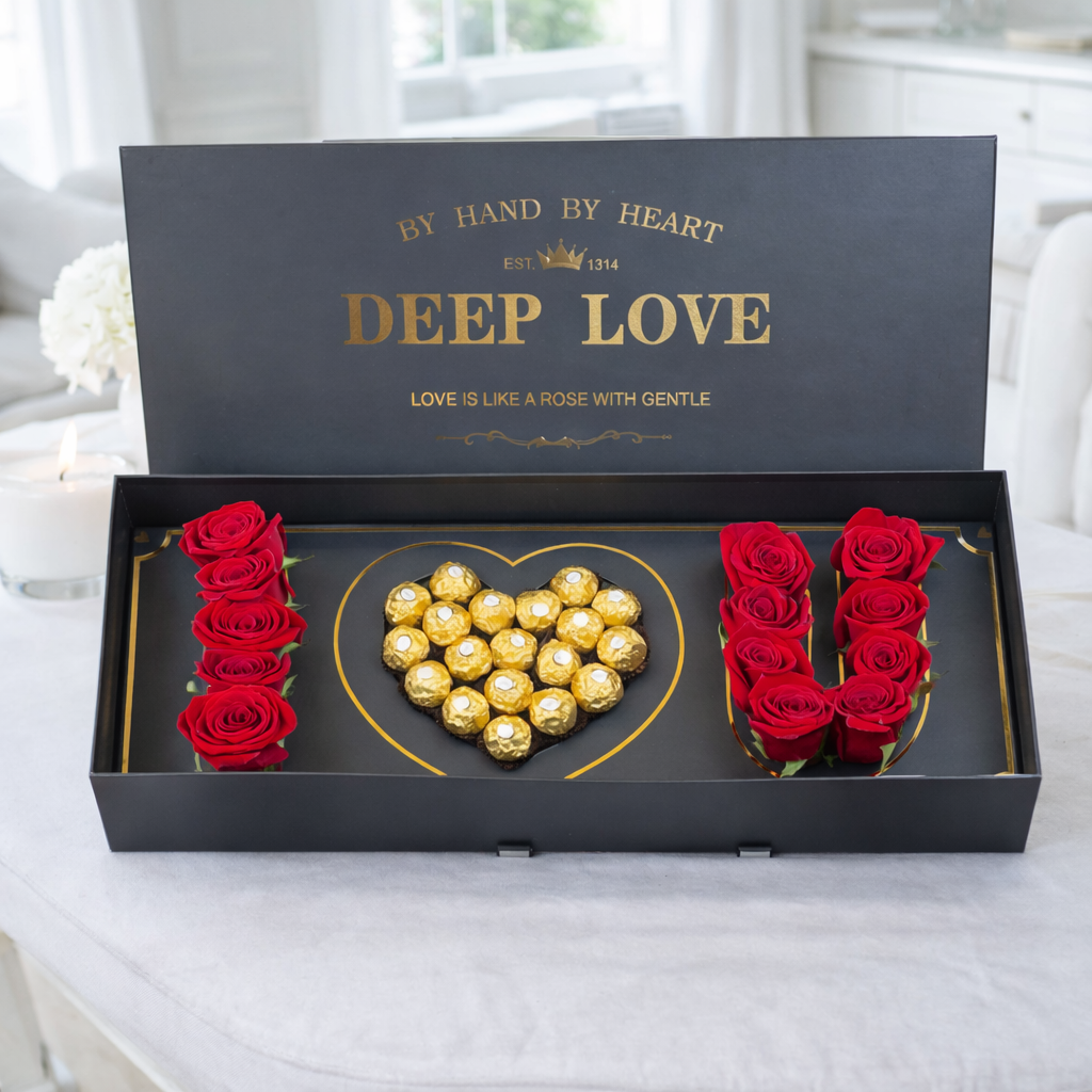 Red roses and Ferrero Rocher chocolates arranged in "I ♥ U" inside an open black "Deep Love" gift box.