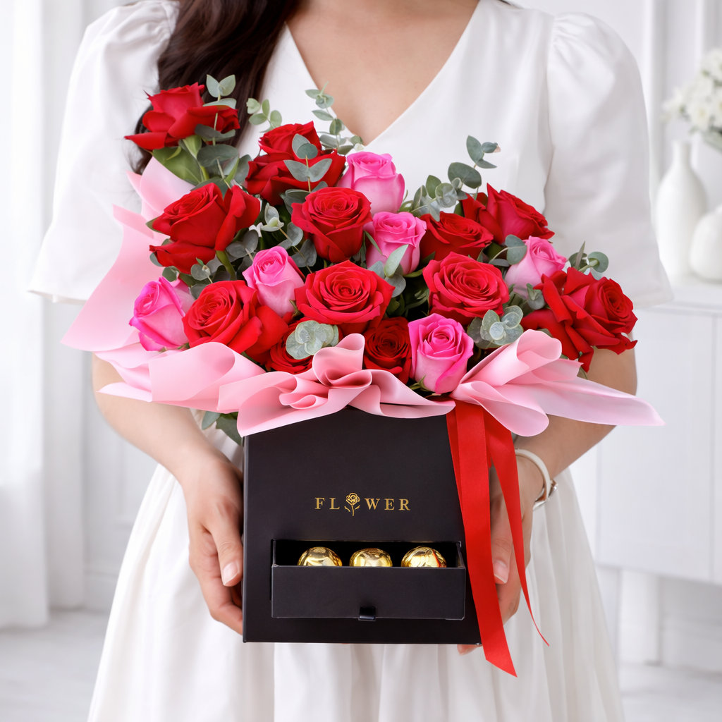 Woman holding red and pink rose box with chocolates