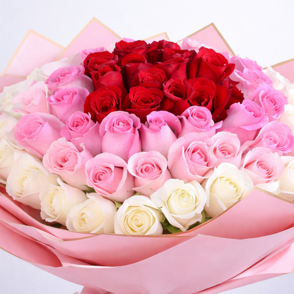 Close-up of red, pink and white roses arranged in round bouquet