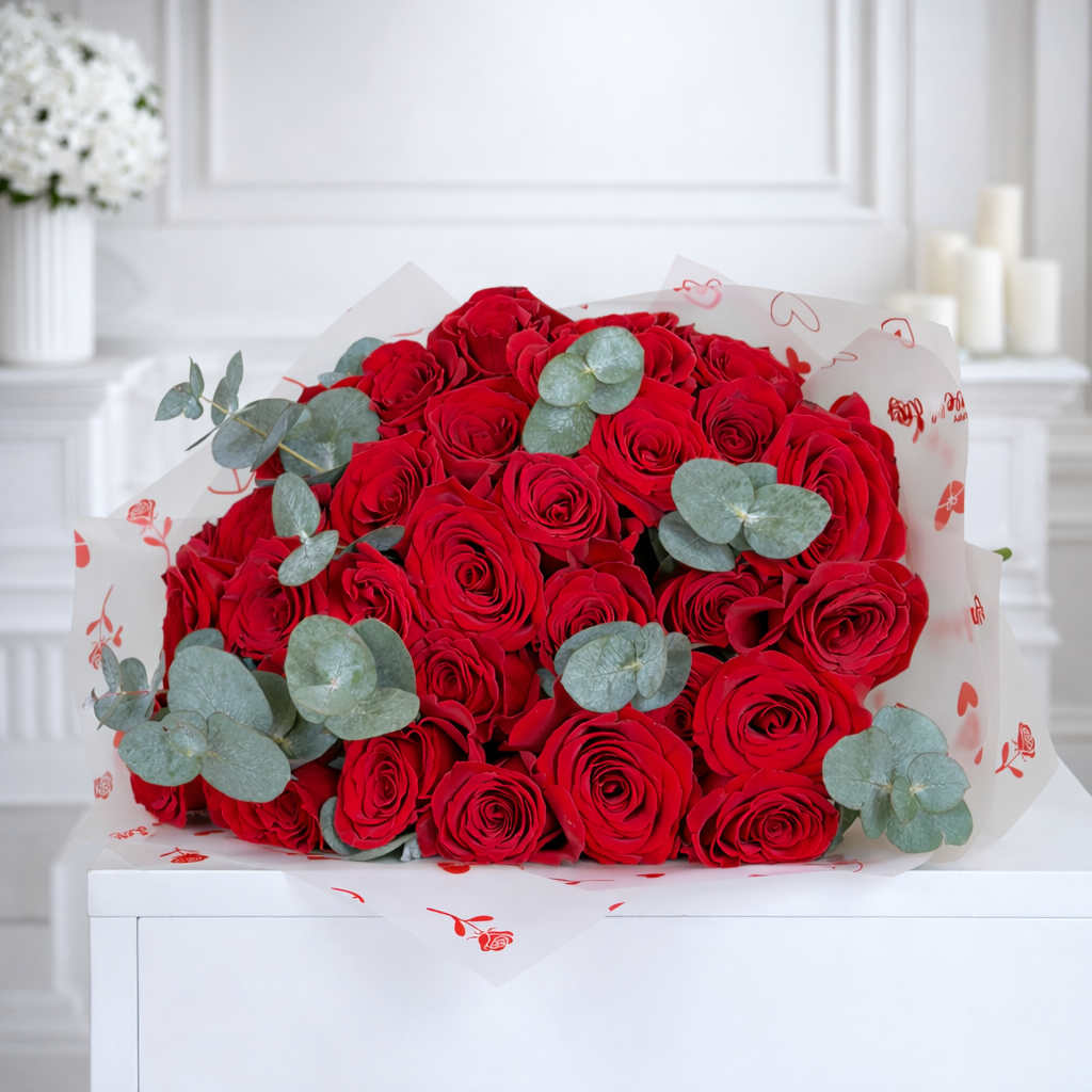 Luxury red roses bouquet with eucalyptus wrapped in decorative paper