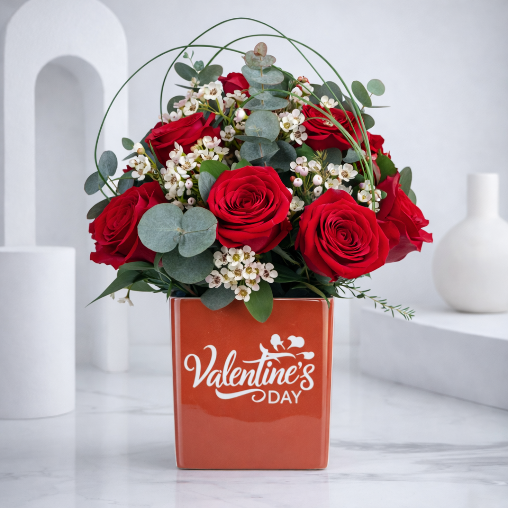 Elegant red roses arrangement with greenery in Valentine gift box