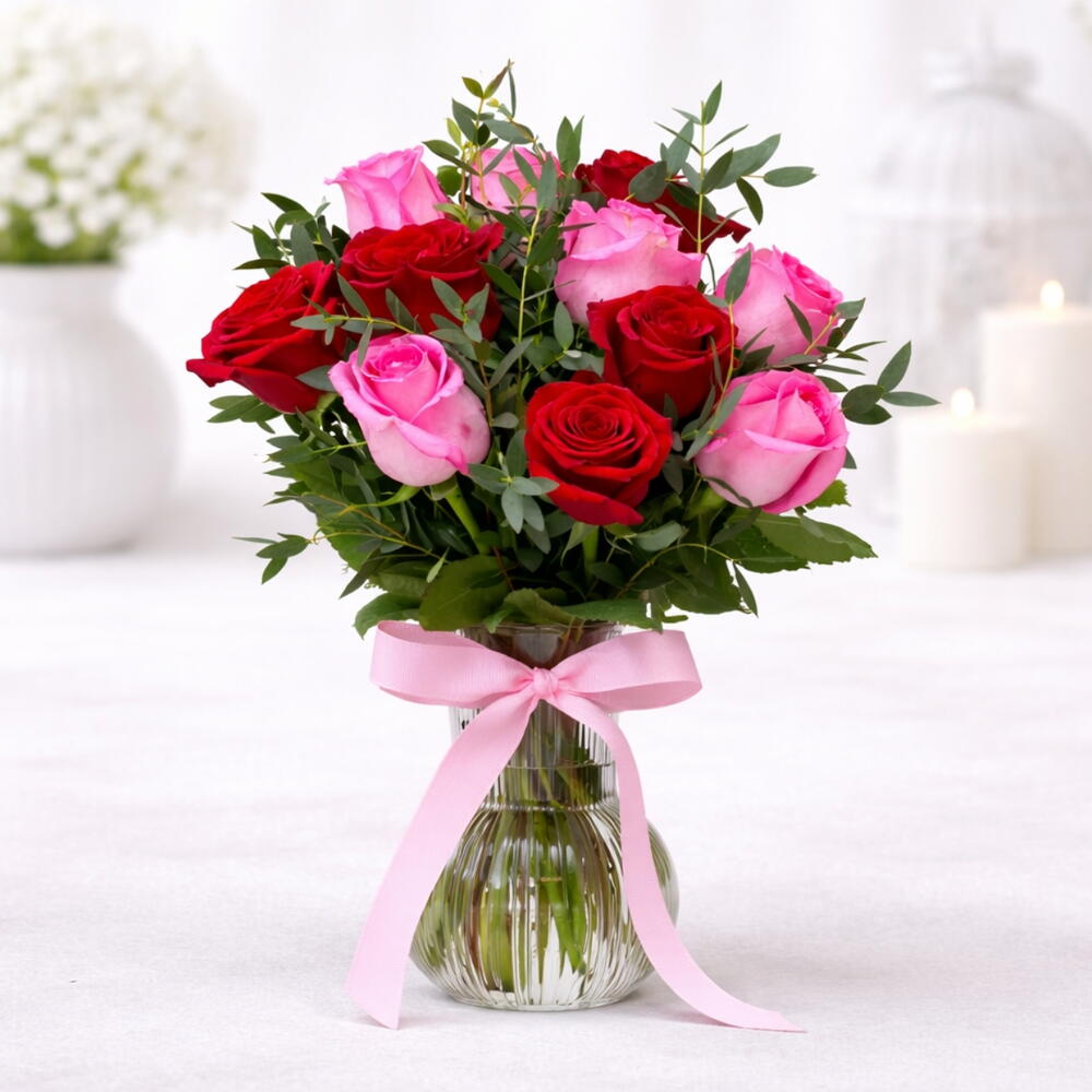 The Moonlit Oasis is a vibrant floral arrangement designed within a modern, white crescent moon-shaped stand.