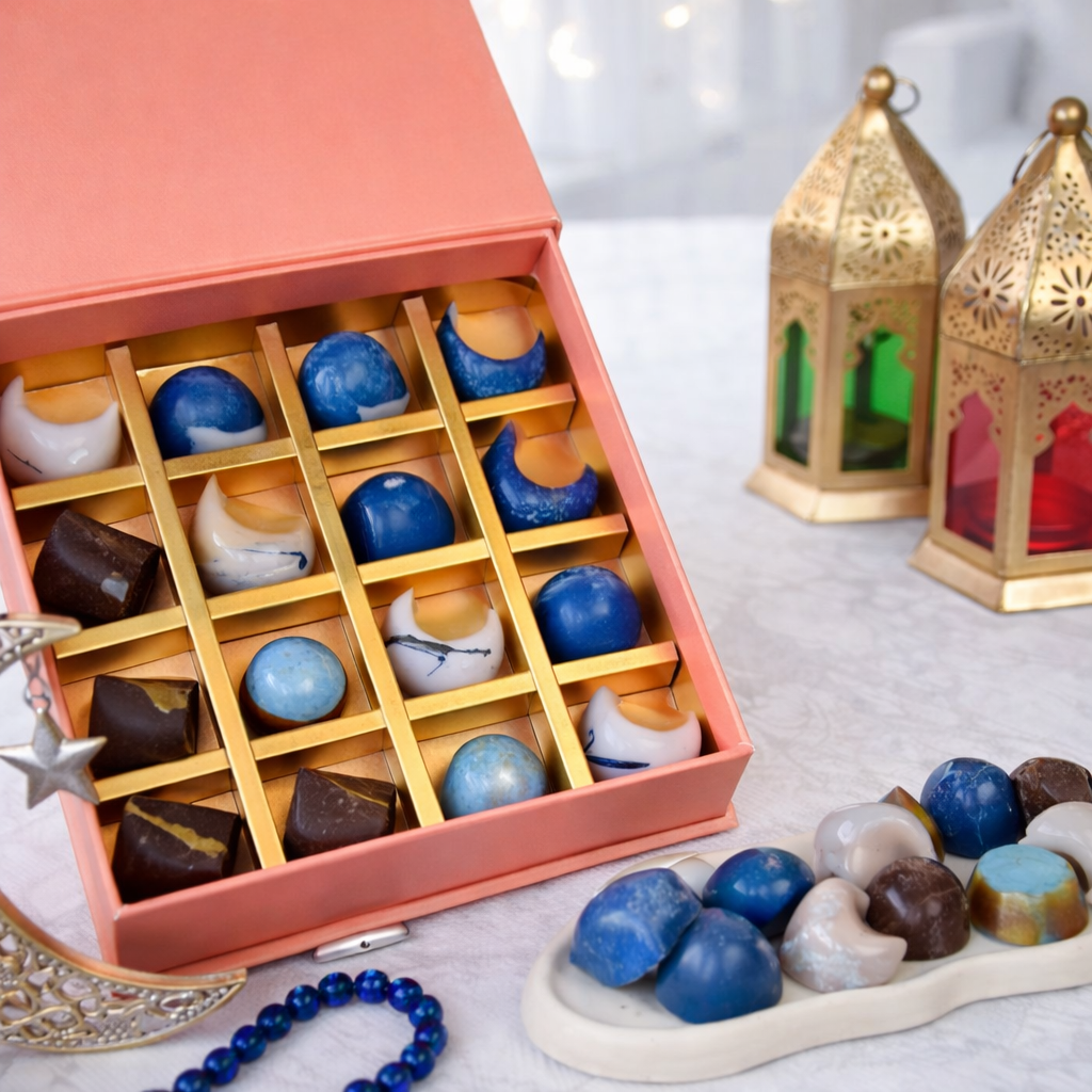 Close-up luxury assorted chocolates in pink box with lantern decor