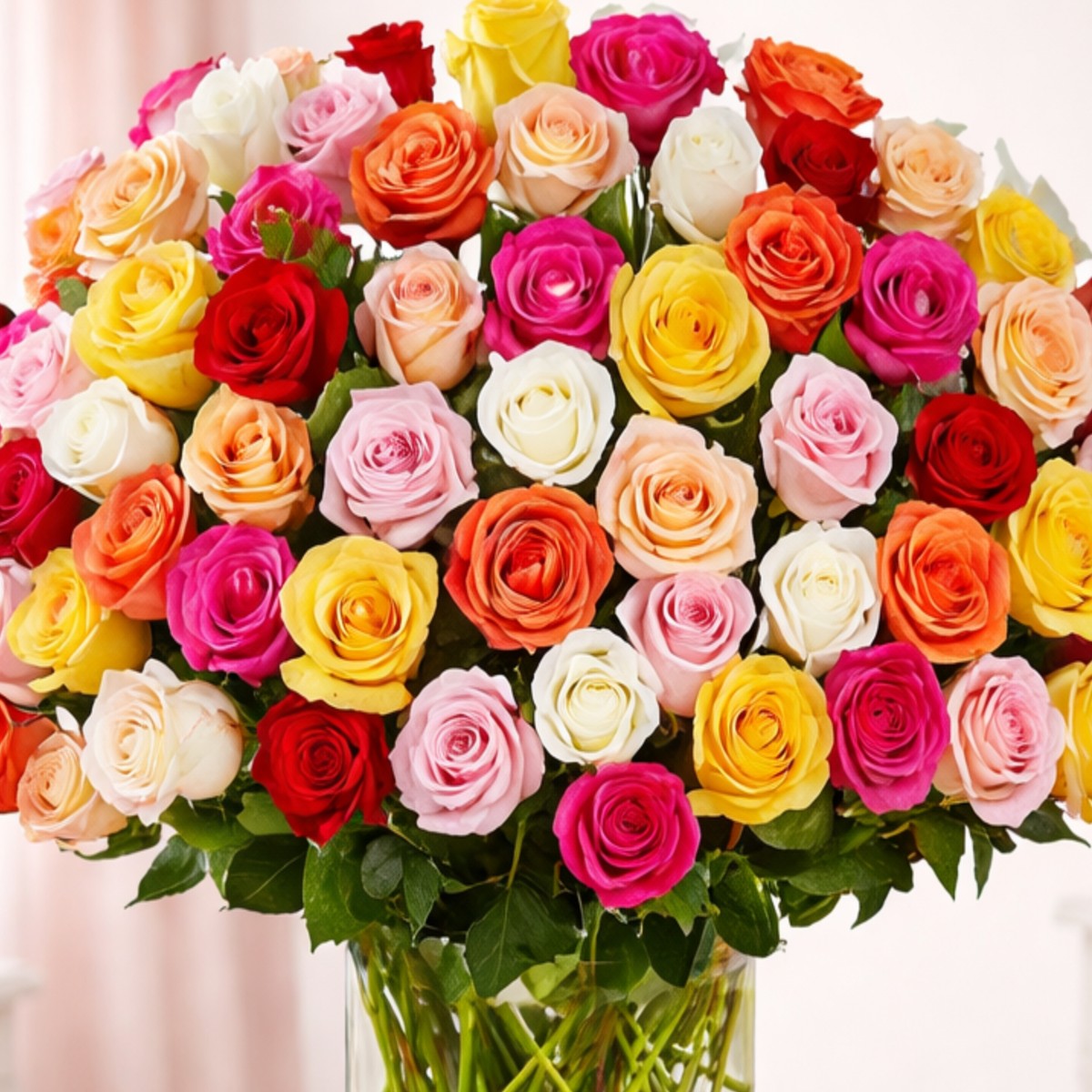 `Close-up of a lush bouquet of multicolored roses in red, pink, orange, yellow, and white.`