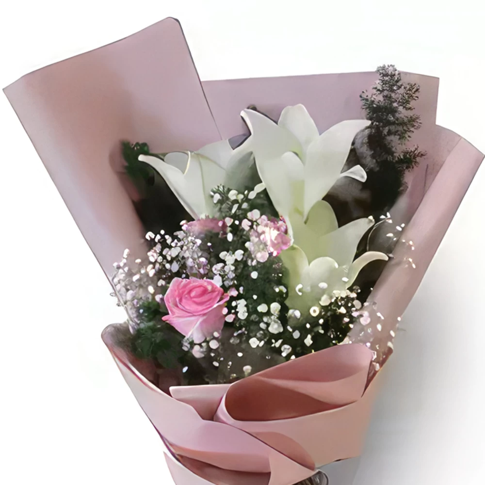 Overhead view of white lilies and pink rose bouquet wrapped in pink paper with baby's breath.