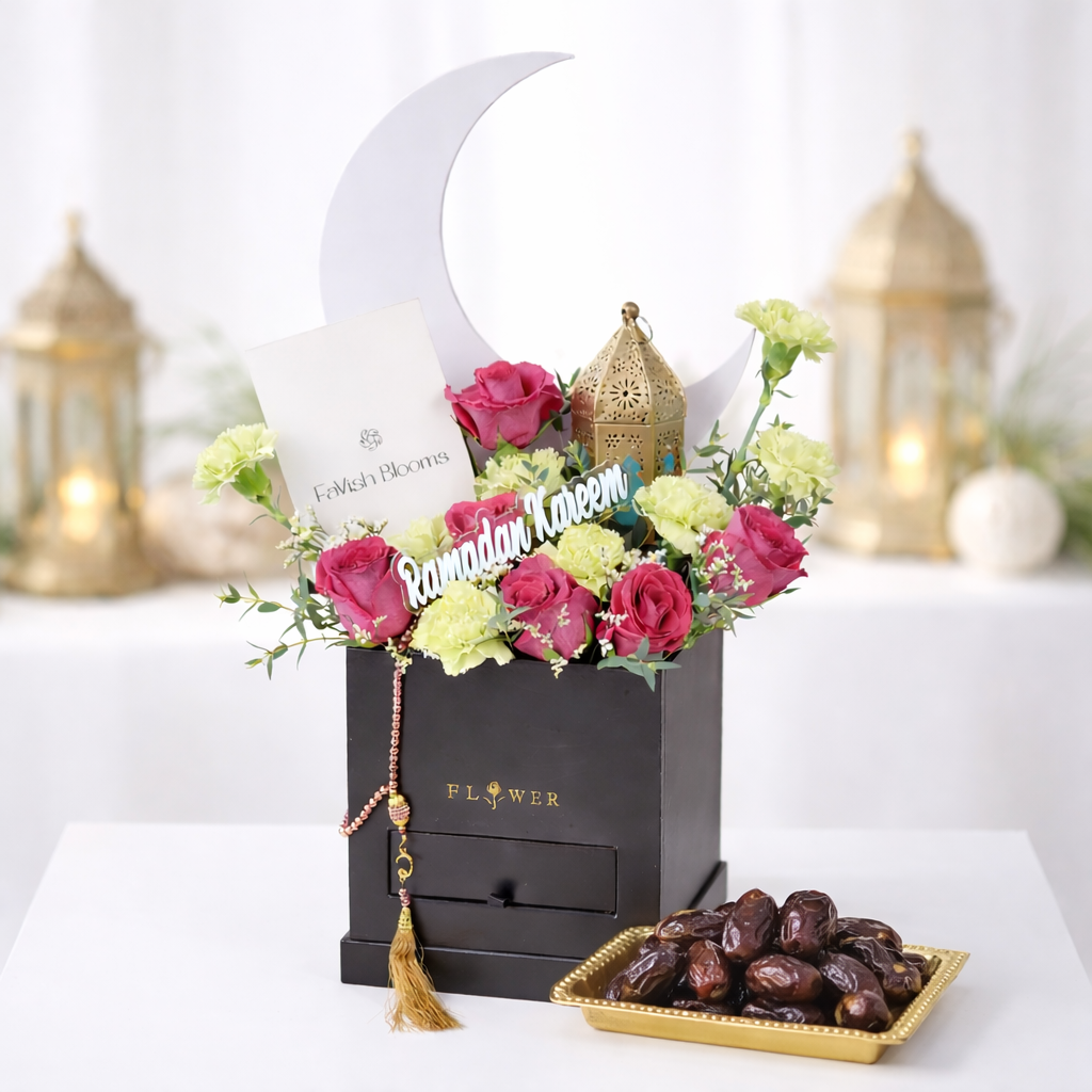 Ramadan Kareem flower box with pink roses, crescent moon decor, prayer beads, and a tray of dates.
