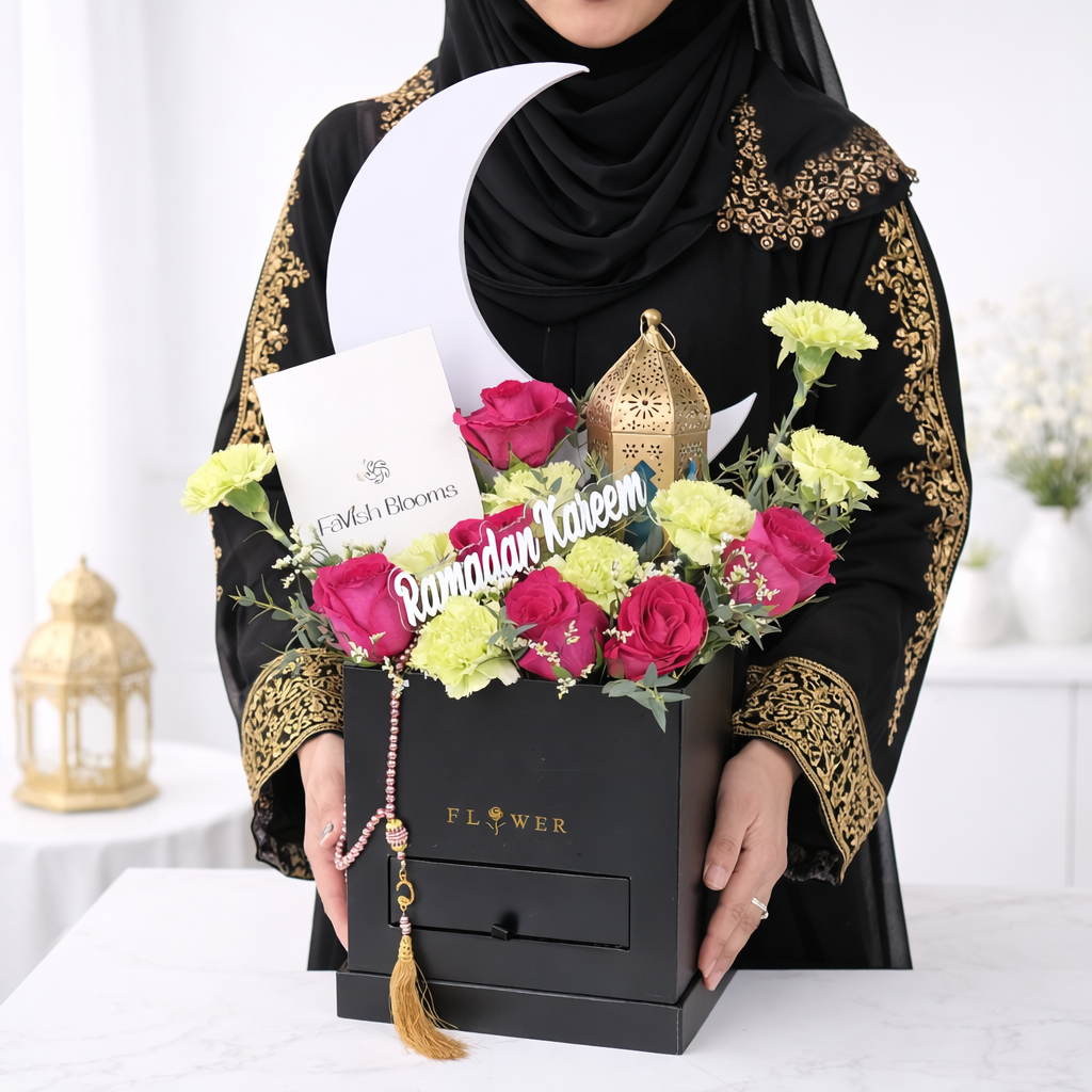 Woman in abaya holding a Ramadan Kareem flower box with pink roses and crescent moon decor.