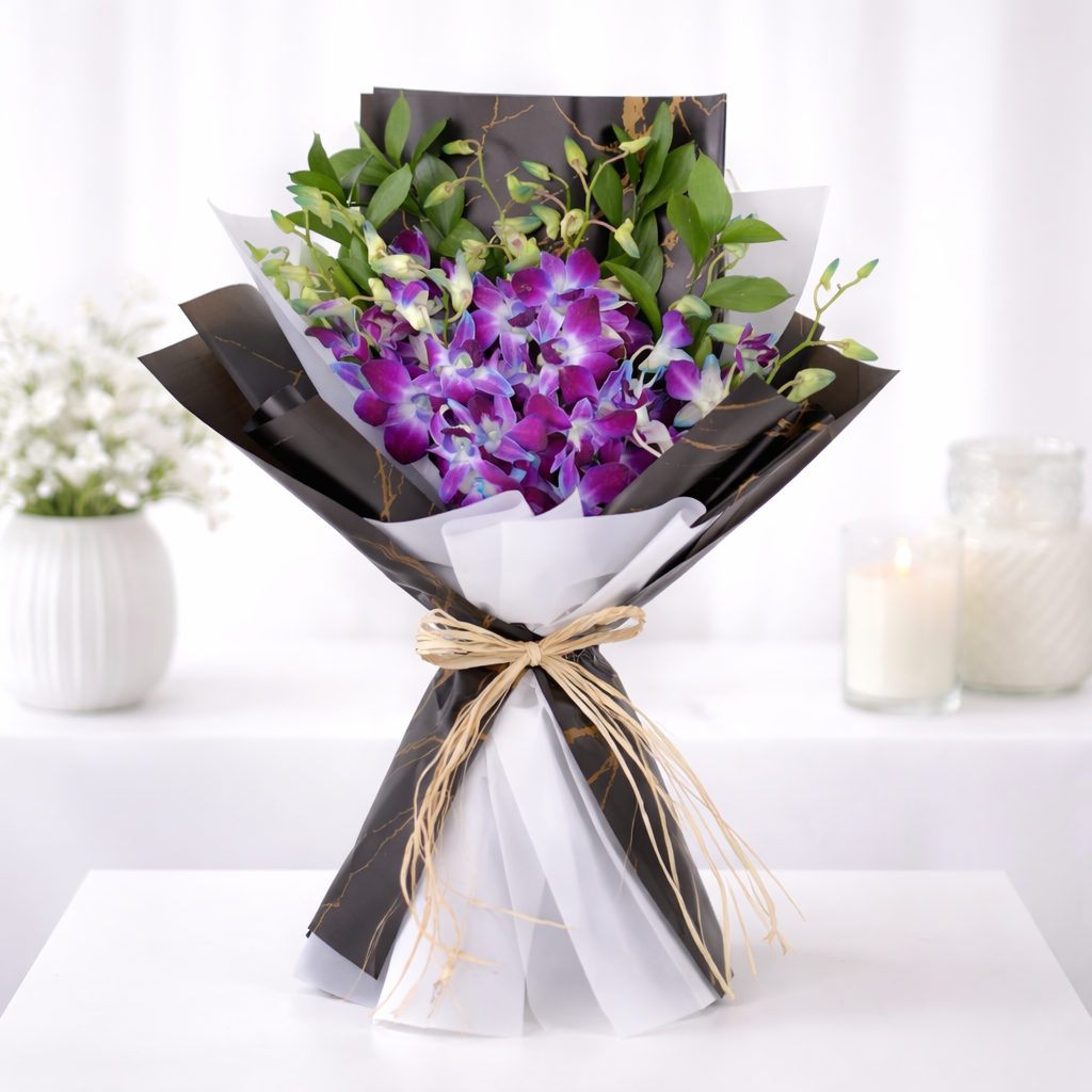 Purple dendrobium orchid bouquet in black marble and white wrapping with raffia bow.
