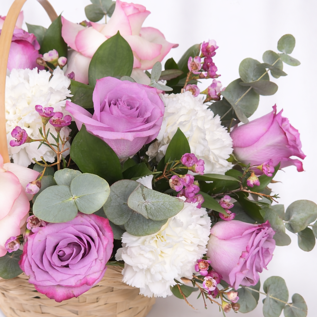 Another close-up, this angle really highlights the rich **lavender roses** — stunning depth of color against the white carnations and eucalyptus! 💜