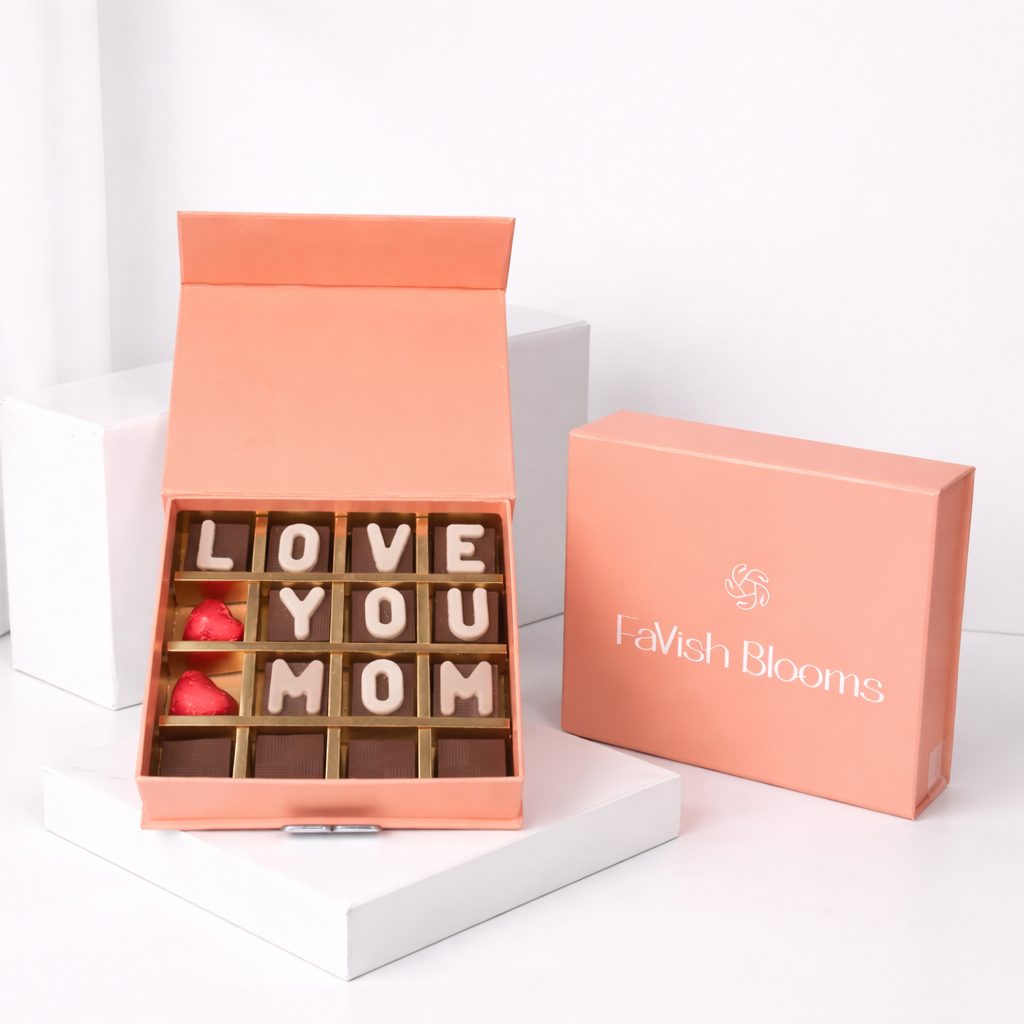 FaVish Blooms "Love You Mom" chocolate letter box with heart-shaped chocolates in a peach gift box.