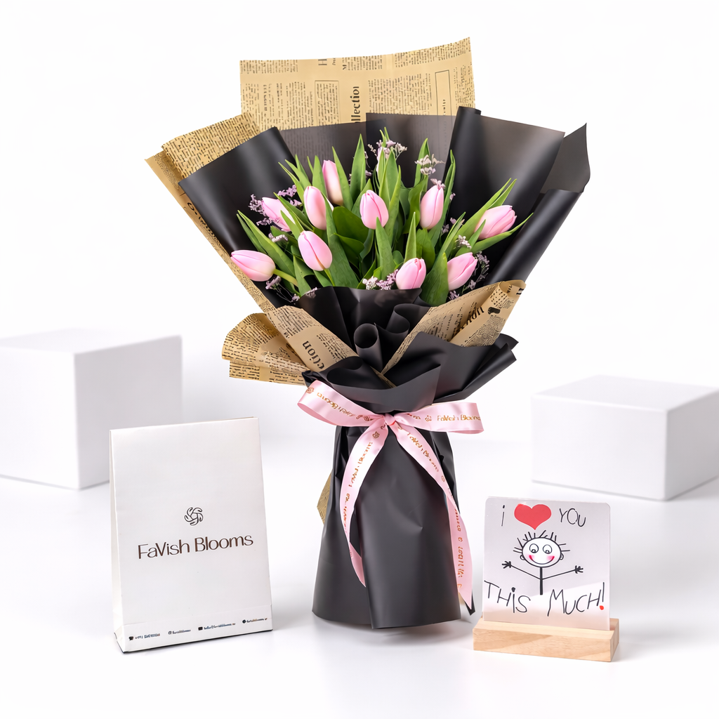 Pink tulip bouquet in black and newspaper wrap with FaVish Blooms gift box and "I Love You This Much" greeting card.