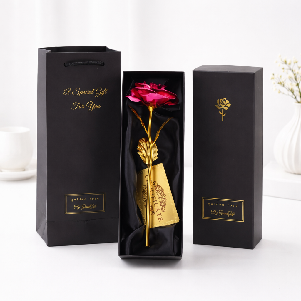 A gold-stemmed artificial pink rose in an open black gift box, with matching black packaging and gift bag labeled "A Special Gift For You" by Golden Rose.