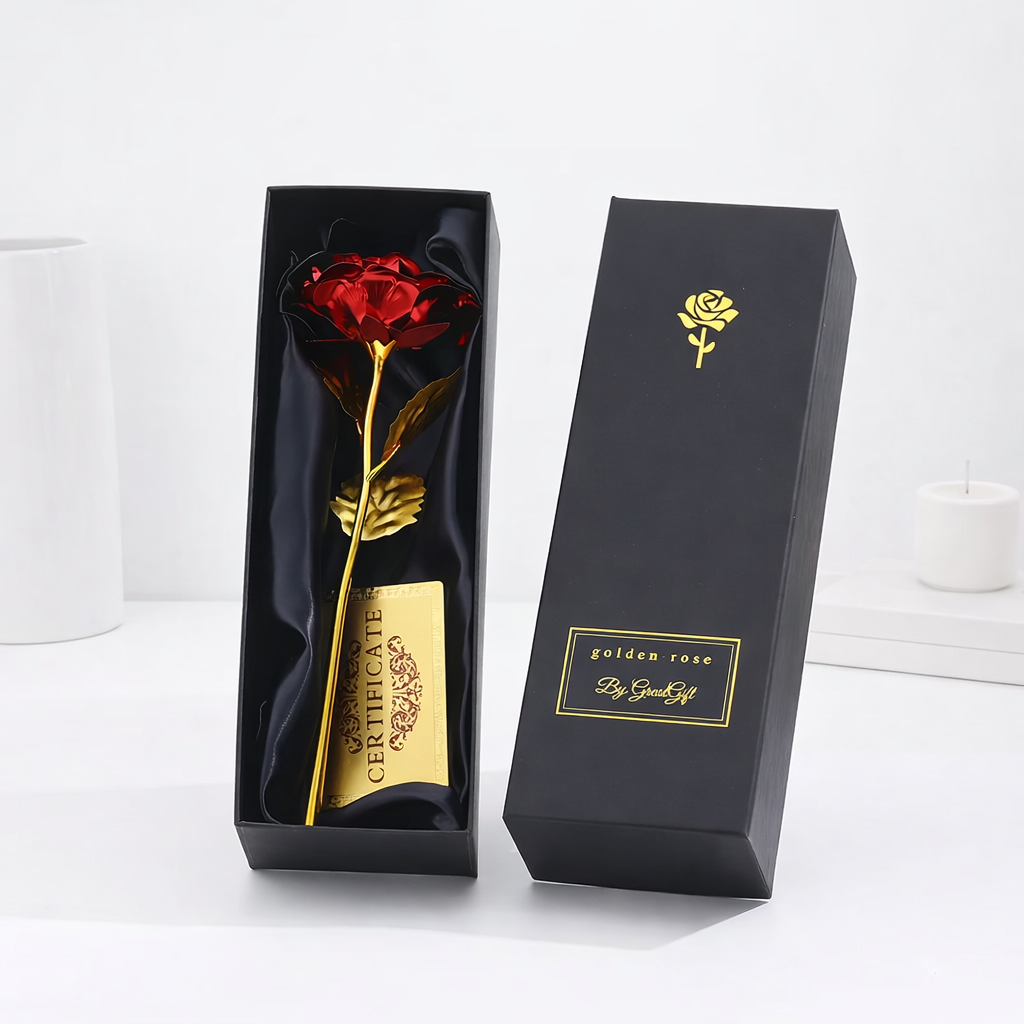 Red metallic artificial rose with a gold stem and certificate, displayed in an open black satin-lined gift box by Golden Rose.