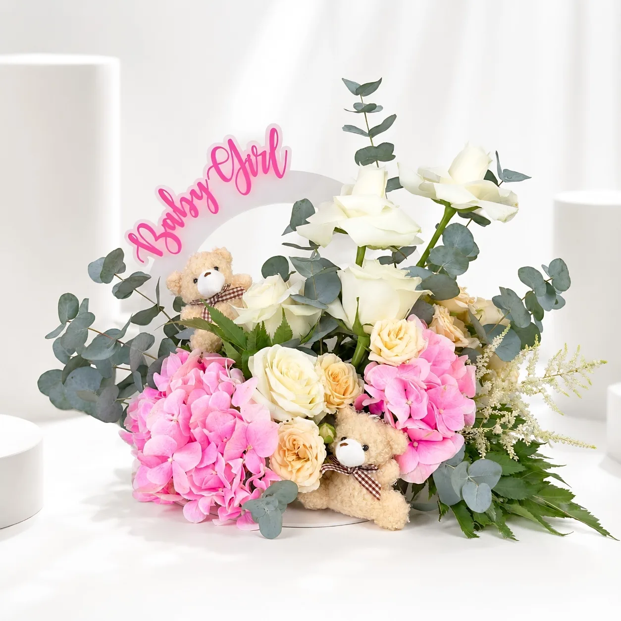 Baby girl welcome floral arrangement with pink hydrangeas and teddy bears