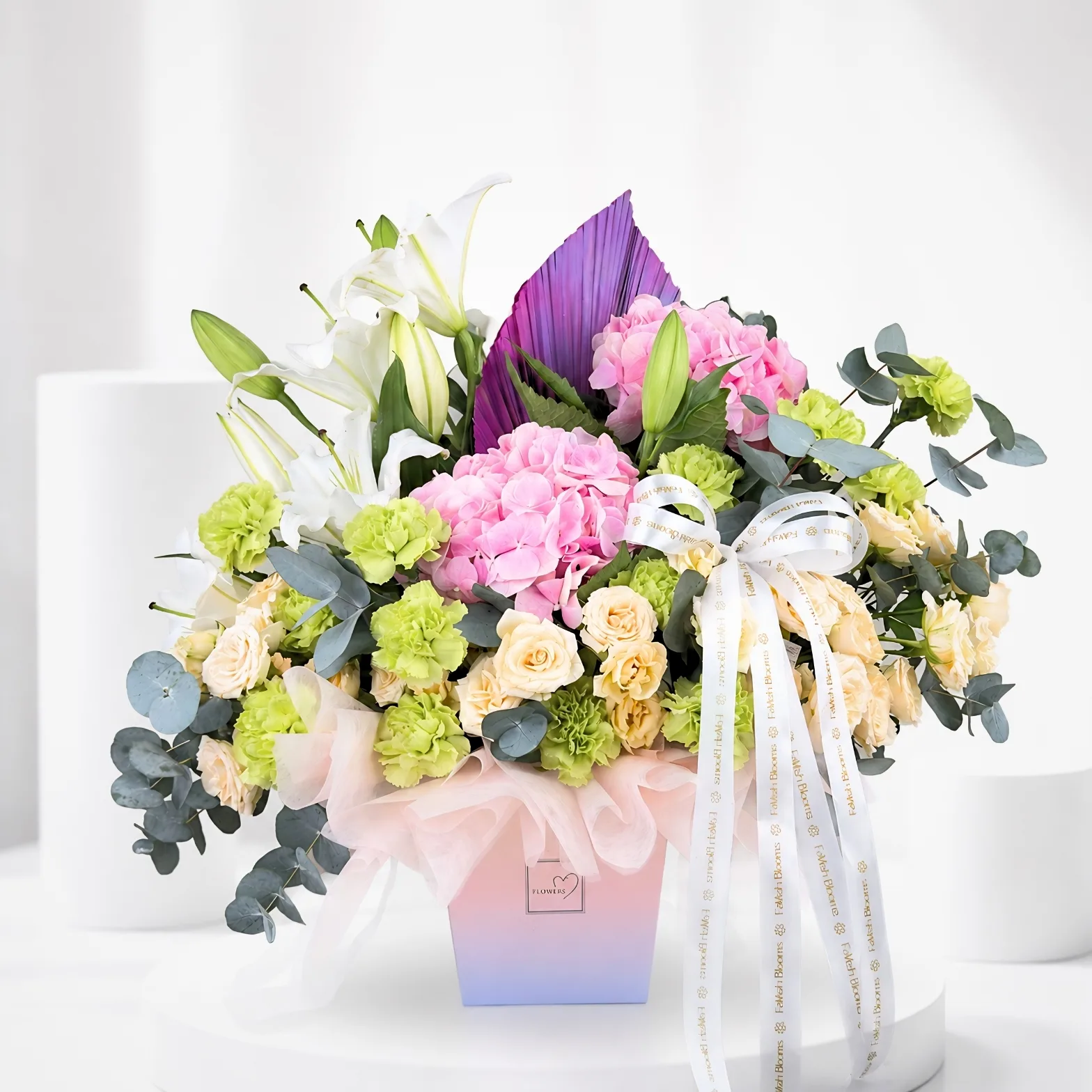 Pastel mixed flower arrangement in colourful rainbow gift box