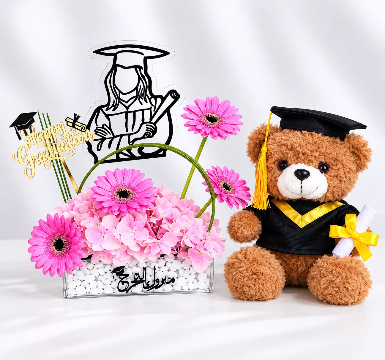 Graduation flower arrangement with teddy bear and graduate topper.